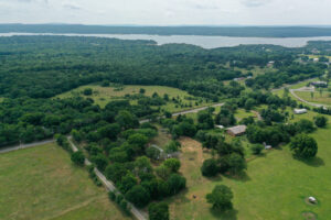 Front exterior view of a remodeled 3-bedroom lake house for sale near Lake Eufaula at 528 Stephens Road, Eufaula, OK.